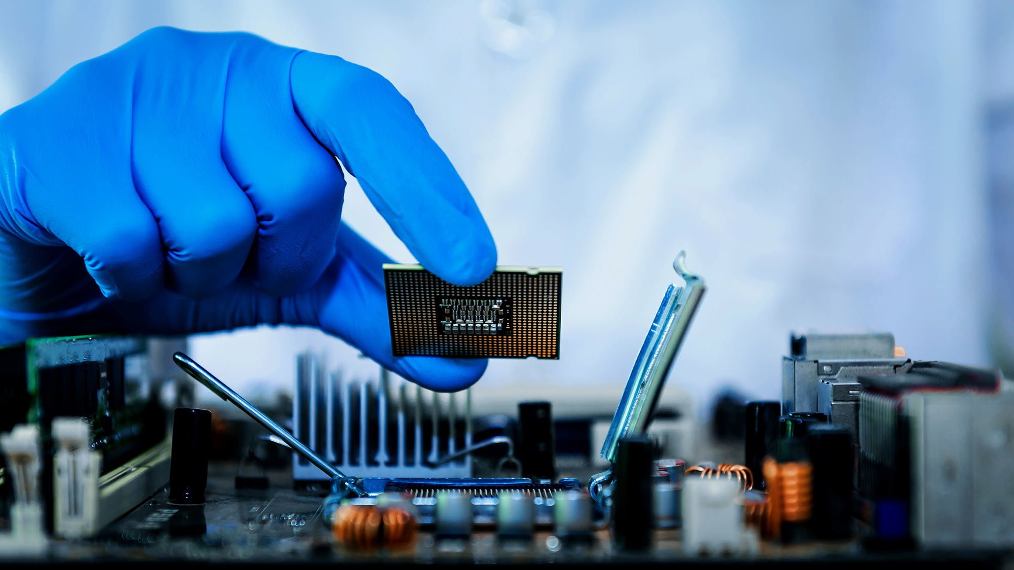 Photo of gloved hand holding microchip